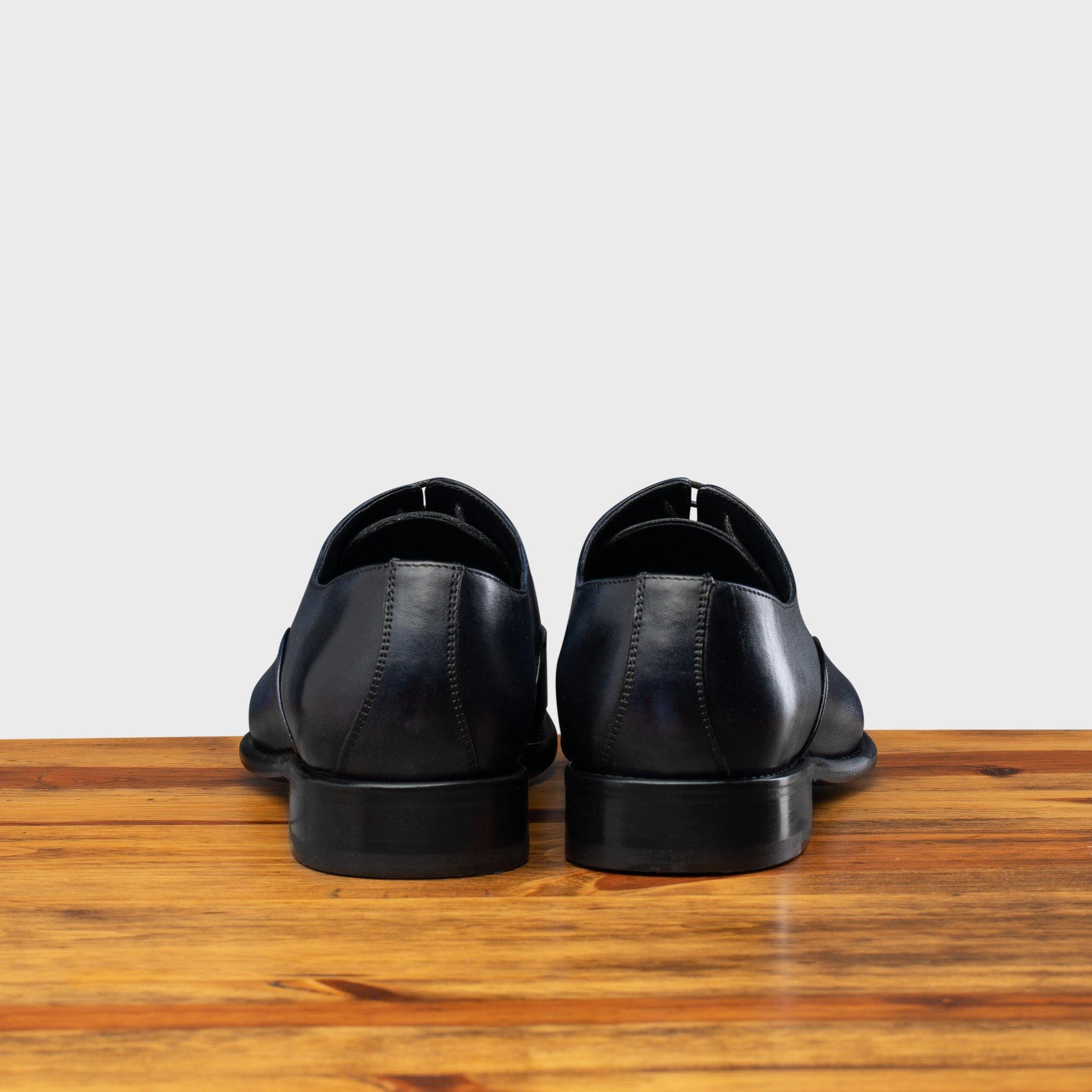 Back profile of the 2361 Calzoleria Toscana Blue Cayenne Calf Cap Toe on top of a wooden table